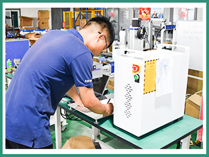 Factory technicians inspect laser machine products